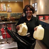 Person with milk jugs at Atlanta Airport Starbucks.jpg